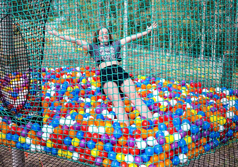 Young girl playing in Wild Nets ball pit